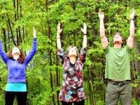 Three people doing Qi Gong stretches