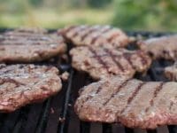 close up of burgers on a bbq grill