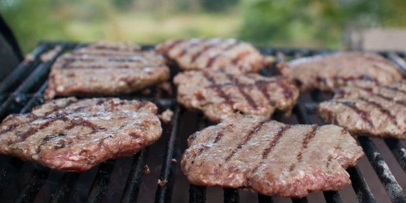 close up of burgers on a bbq grill