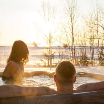 Couple in an outdoor hot tub in winter.