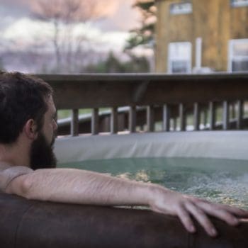 Man sitting in an outdoor hot tub