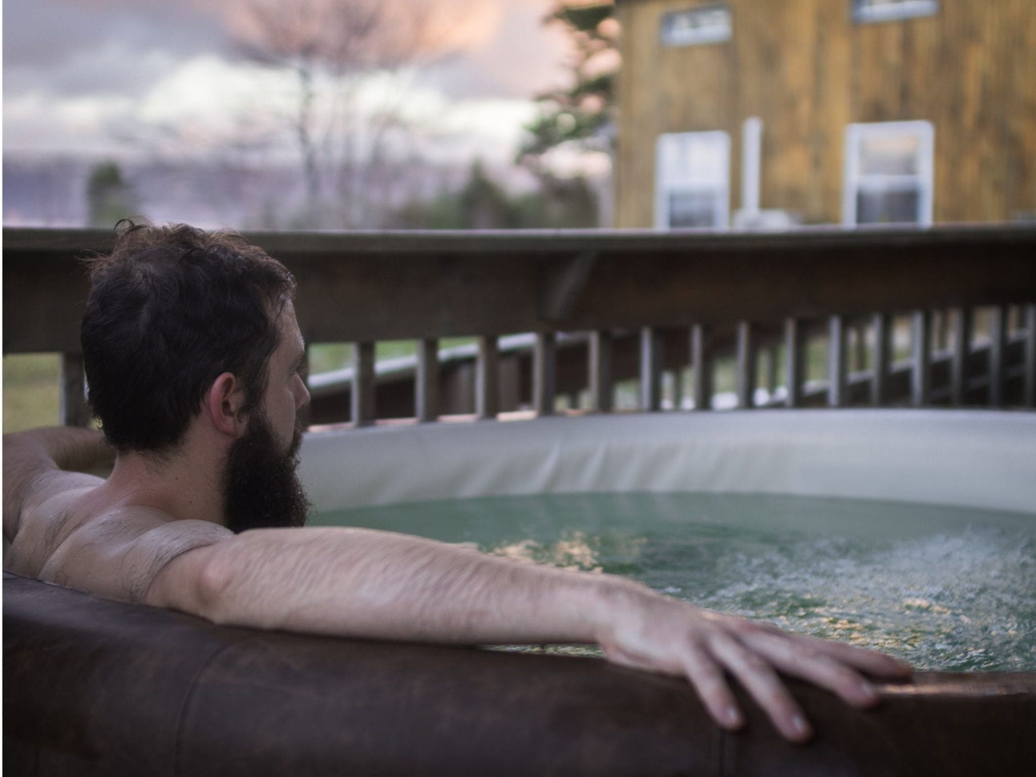 Man sitting in an outdoor hot tub