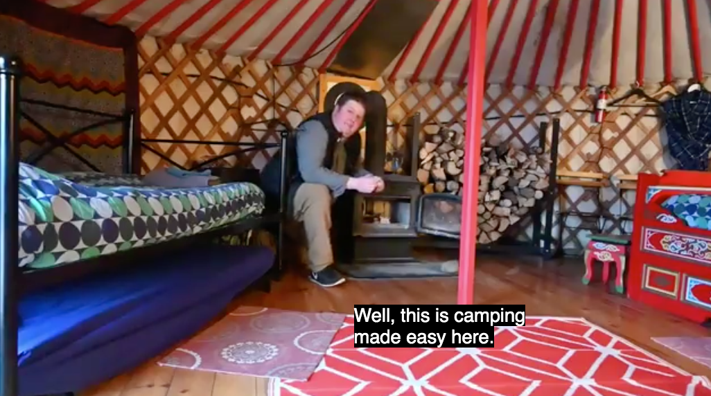 Nathan Coleman sitting inside a yurt. Caption: Well, this is camping made easy here.