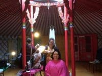 woman getting her hair styled inside a yurt