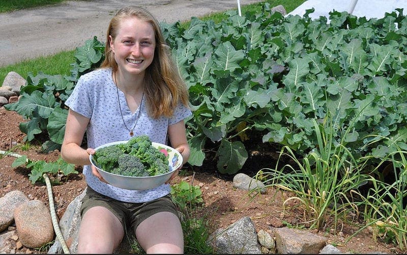 Hannah holding a bowl of fresh garden produce
