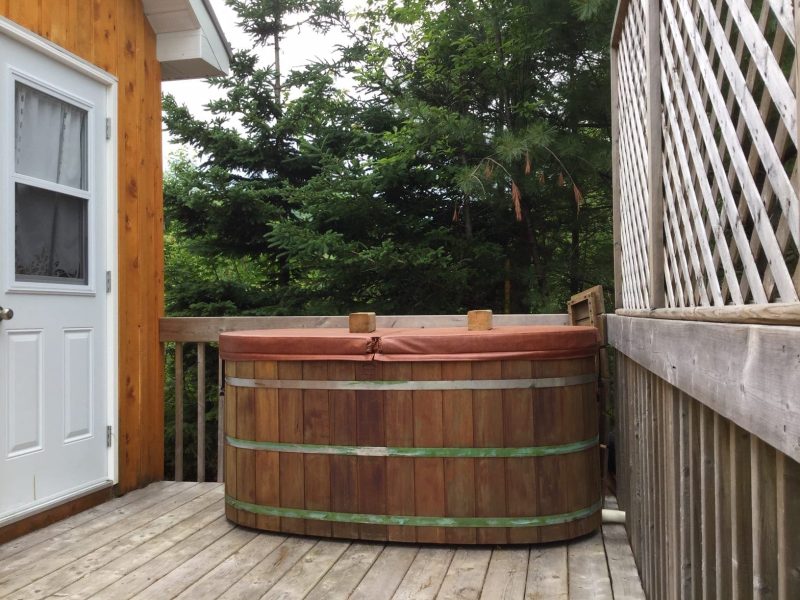 The Tiny House at Cabot Shores Tiny house deck and hot tub.