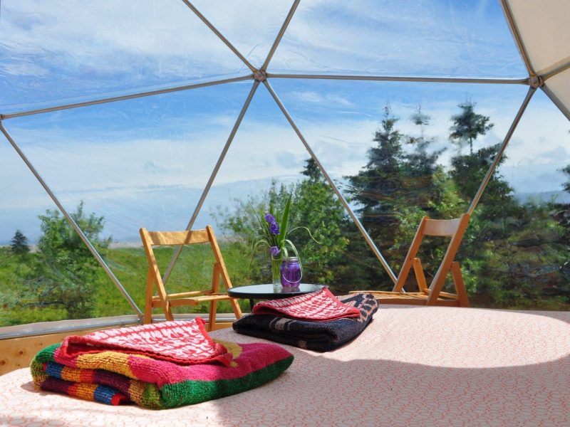 Stay-Domes Geodesic dome interior bed, table and chairs.