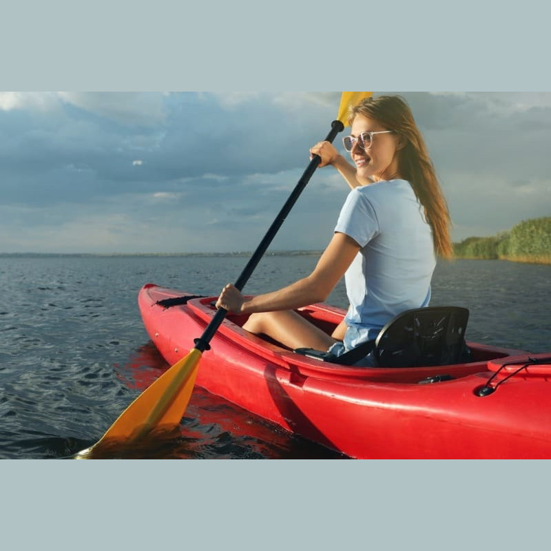 Packages-General Cape Breton Kayak: A woman smiles as she enjoys kayaking along the shores of Cape Breton Island, Nova Scotia.
