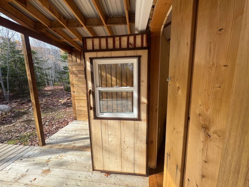 The Highlands Yurt at Cabot Shores Highland Yurt entrance with natural pine finish and curved doorway