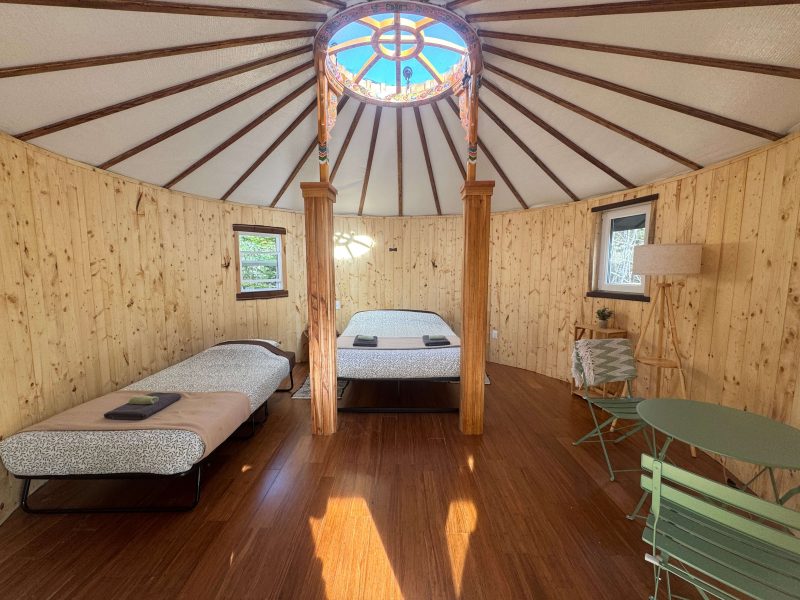 The Highlands Yurt at Cabot Shores Cozy interior of the Highland Yurt with bamboo flooring and natural light