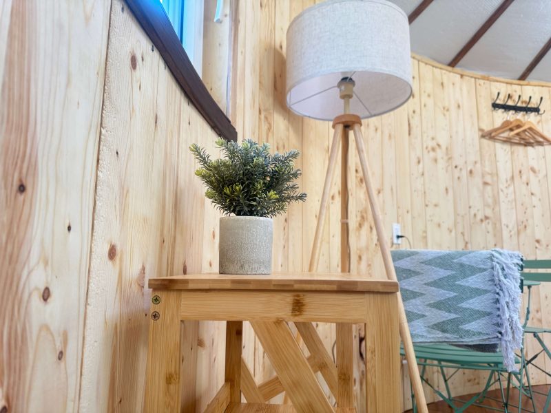 The Highlands Yurt at Cabot Shores Cozy interior featuring lamps, and side tables