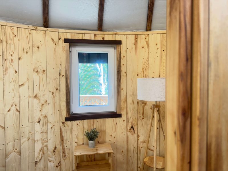 The Highlands Yurt at Cabot Shores Hand-carved wooden window frames and natural wood detailing